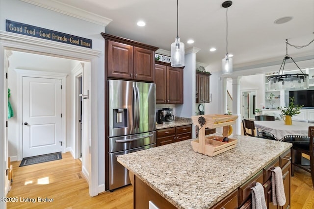 13318 Stepping Stone Way, Louisville, KY 40299 - kitchen featuring stainless steel refrigerator with ice dispenser, crown molding, ornate columns, a kitchen island, and light stone countertops