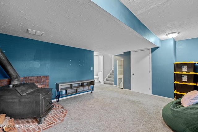 3802 Breckenridge Ln, Louisville, KY 40218 - living area featuring a textured ceiling, a wood stove, stairs, baseboards, and carpet