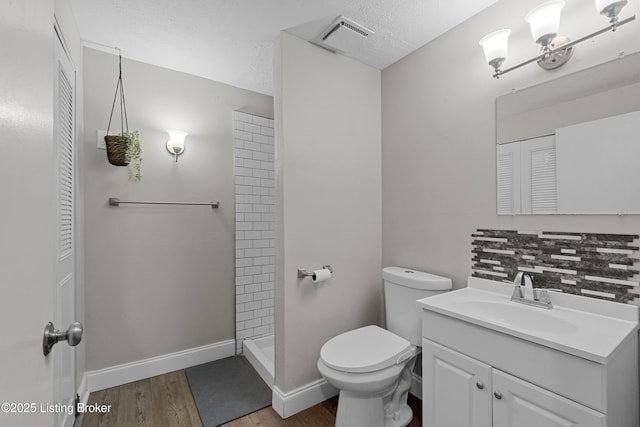 3802 Breckenridge Ln, Louisville, KY 40218 - full bathroom with vanity, toilet, wood finished floors, tiled shower, and backsplash