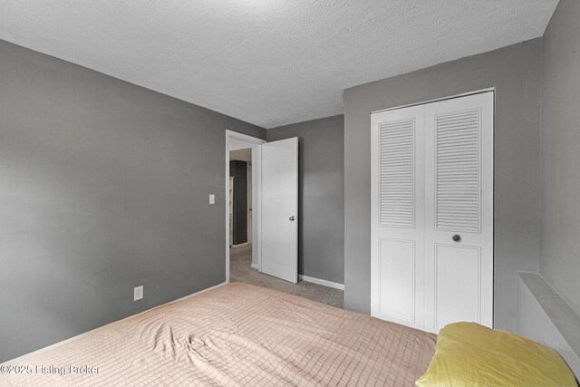 3802 Breckenridge Ln, Louisville, KY 40218 - carpeted bedroom with a closet, baseboards, and a textured ceiling