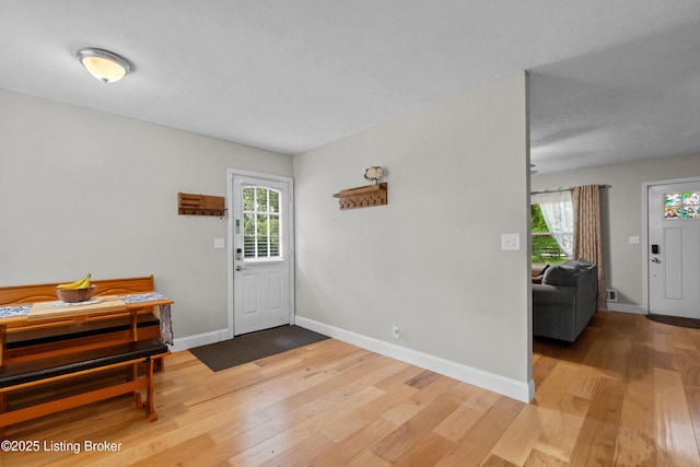 3802 Breckenridge Ln, Louisville, KY 40218 - entryway featuring light wood-type flooring, baseboards, and a textured ceiling