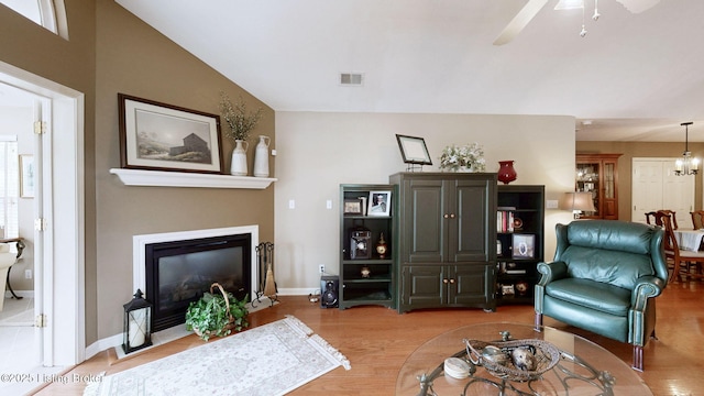 10409 Pine Glen Cir, Louisville, KY 40291 - living room with light wood-type flooring, ceiling fan, a fireplace with flush hearth, baseboards, and lofted ceiling