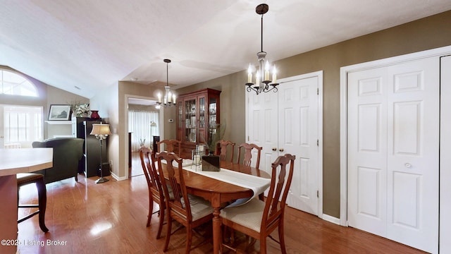 10409 Pine Glen Cir, Louisville, KY 40291 - dining space featuring a chandelier, wood finished floors, lofted ceiling, and baseboards