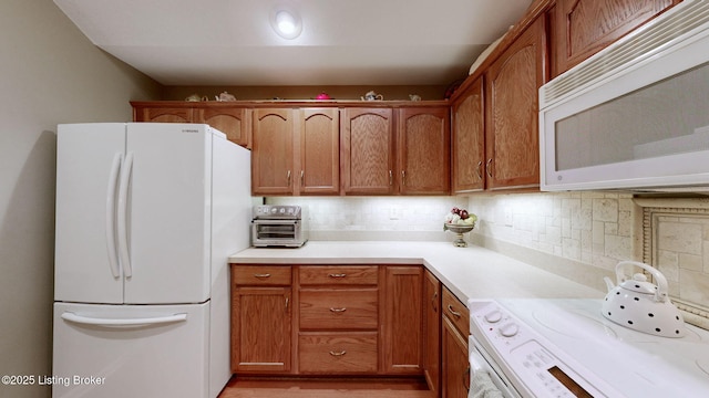 10409 Pine Glen Cir, Louisville, KY 40291 - kitchen with white appliances, tasteful backsplash, light countertops, and brown cabinets