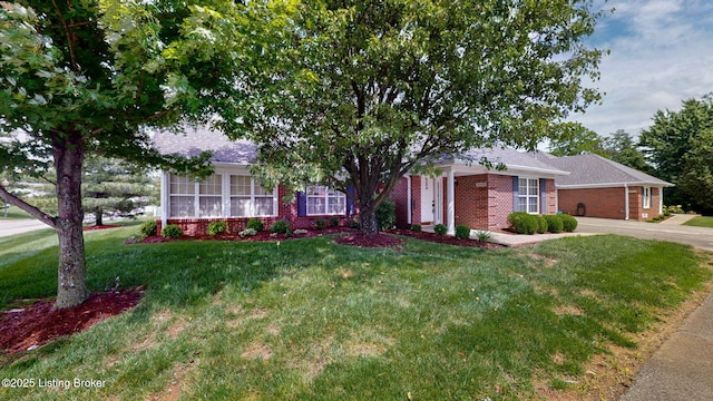 10409 Pine Glen Cir, Louisville, KY 40291 - view of front of home with brick siding, a front lawn, concrete driveway, and a shingled roof