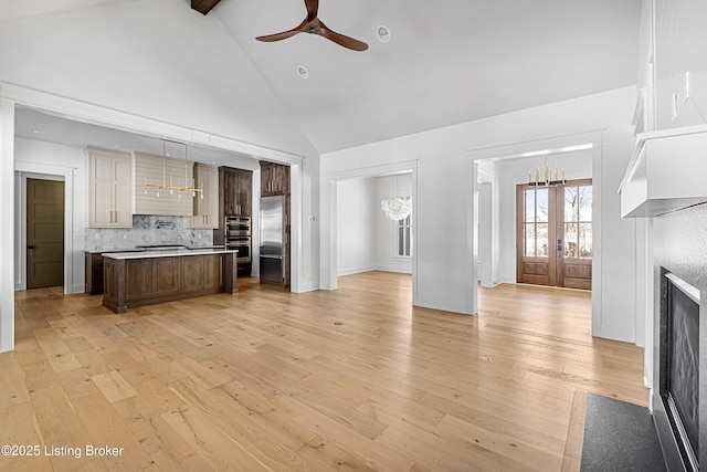 4907 Sycamore Ridge Ln, La Grange, KY 40031 - kitchen with appliances with stainless steel finishes, a chandelier, open floor plan, a ceiling fan, and high vaulted ceiling