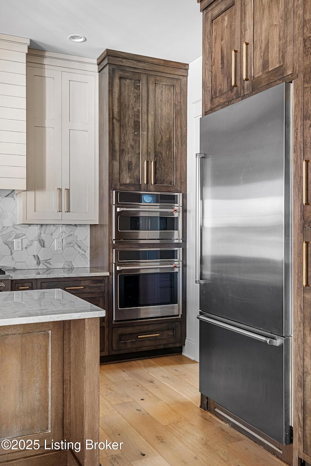 4907 Sycamore Ridge Ln, La Grange, KY 40031 - kitchen with stainless steel appliances, light stone countertops, tasteful backsplash, light wood-style floors, and recessed lighting