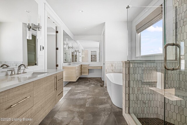 4907 Sycamore Ridge Ln, La Grange, KY 40031 - full bathroom featuring two vanities, a shower stall, a soaking tub, and a wainscoted wall