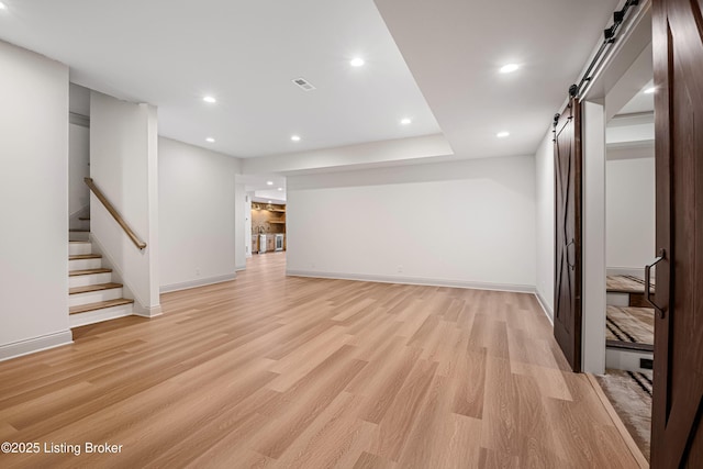 4907 Sycamore Ridge Ln, La Grange, KY 40031 - unfurnished living room featuring a barn door, baseboards, light wood-type flooring, stairs, and recessed lighting