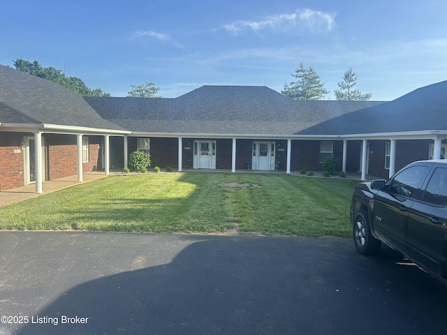 105B Twin Oaks Dr, Bardstown, KY 40004 - view of front of house with a front lawn, brick siding, and roof with shingles