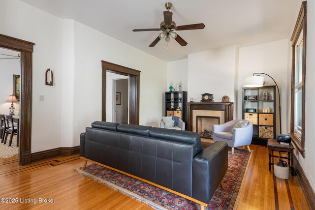 2023 Alta Ave, Louisville, KY 40205 - living area with wood finished floors, ceiling fan, a brick fireplace, and baseboards