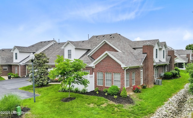 10119 Vista Springs Way, Louisville, KY 40291 - traditional-style house with brick siding, a shingled roof, a front yard, central AC, and driveway