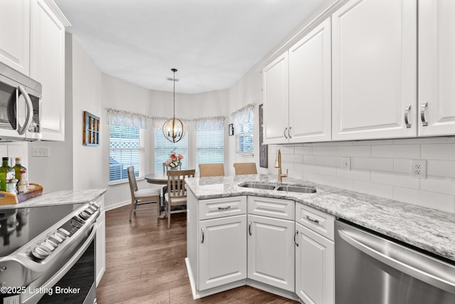 10119 Vista Springs Way, Louisville, KY 40291 - kitchen featuring stainless steel appliances, a sink, white cabinets, a chandelier, and decorative backsplash
