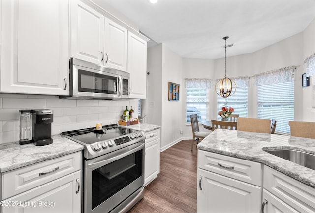 10119 Vista Springs Way, Louisville, KY 40291 - kitchen featuring appliances with stainless steel finishes, a chandelier, tasteful backsplash, wood finished floors, and white cabinets