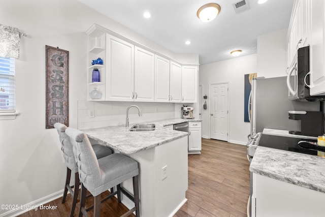 10119 Vista Springs Way, Louisville, KY 40291 - kitchen with a sink, stainless steel microwave, white cabinetry, baseboards, and recessed lighting