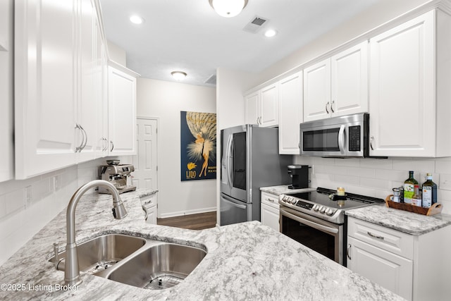 10119 Vista Springs Way, Louisville, KY 40291 - kitchen featuring appliances with stainless steel finishes, a sink, white cabinets, backsplash, and recessed lighting