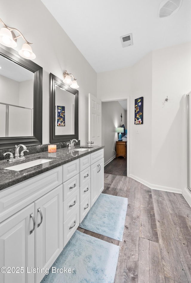 10119 Vista Springs Way, Louisville, KY 40291 - bathroom featuring wood finished floors, double vanity, and baseboards