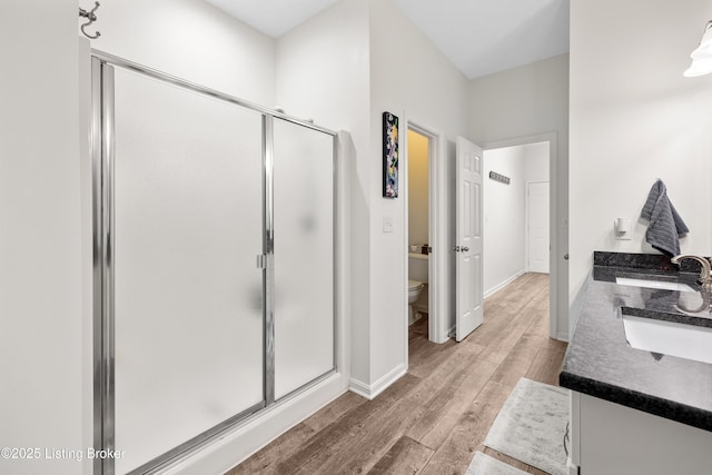 10119 Vista Springs Way, Louisville, KY 40291 - full bathroom with a shower stall, wood finished floors, toilet, and baseboards