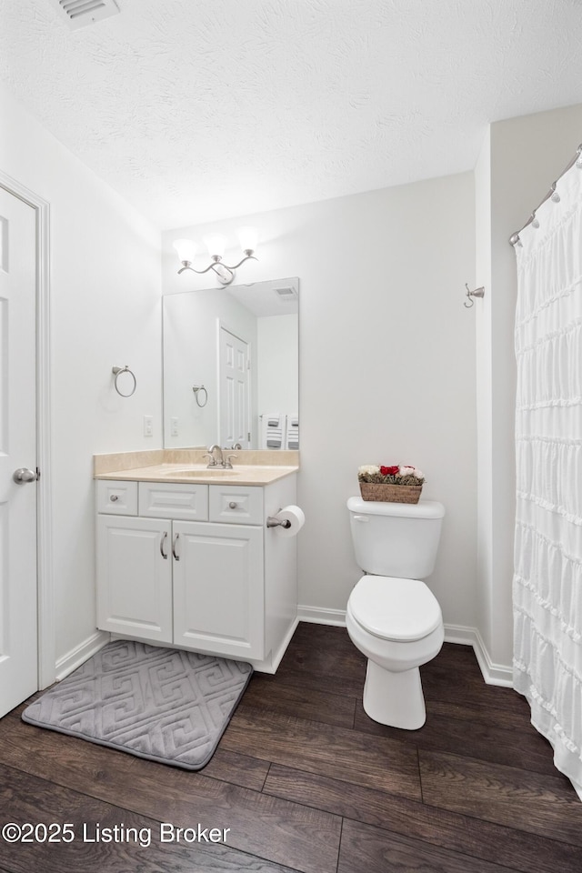 10119 Vista Springs Way, Louisville, KY 40291 - bathroom with wood finished floors, vanity, toilet, baseboards, and a textured ceiling