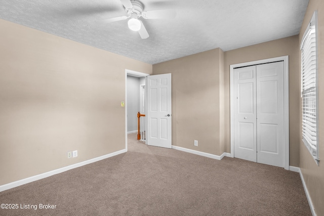 1312 Pollitt Ct, Louisville, KY 40223 - unfurnished bedroom featuring carpet floors, baseboards, a textured ceiling, a closet, and ceiling fan
