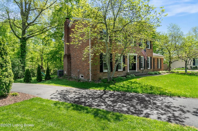1312 Pollitt Ct, Louisville, KY 40223 - view of front of house featuring brick siding, a chimney, and a front yard