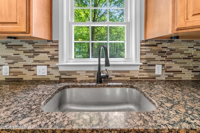 1312 Pollitt Ct, Louisville, KY 40223 - kitchen view of a sink, decorative backsplash, and dark stone counters