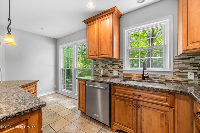 1312 Pollitt Ct, Louisville, KY 40223 - kitchen featuring stainless steel dishwasher, a sink, backsplash, brown cabinetry, and baseboards