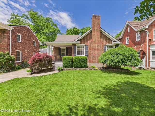 4932 Southern Pkwy, Louisville, KY 40214 - view of front of home featuring a chimney, a porch, a front yard, and brick siding