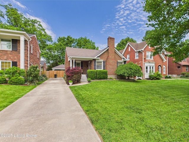 4932 Southern Pkwy, Louisville, KY 40214 - view of front facade featuring a chimney, concrete driveway, and brick siding