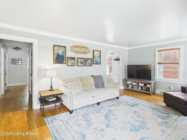 4932 Southern Pkwy, Louisville, KY 40214 - living room with arched walkways, plenty of natural light, wood finished floors, and crown molding