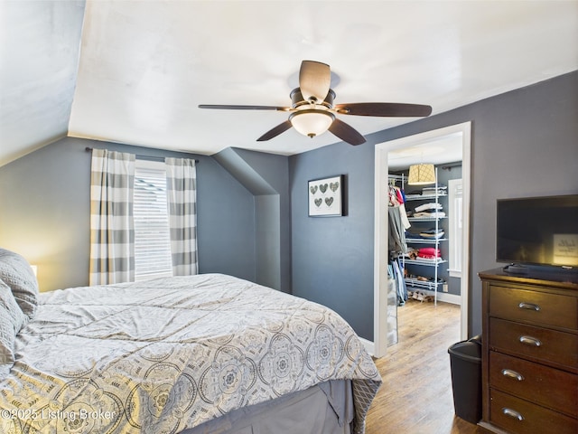4932 Southern Pkwy, Louisville, KY 40214 - bedroom featuring a walk in closet, wood finished floors, a closet, a ceiling fan, and lofted ceiling