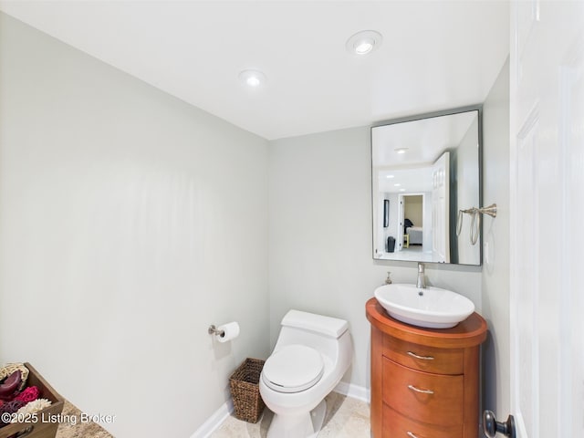 4932 Southern Pkwy, Louisville, KY 40214 - bathroom featuring toilet, vanity, baseboards, and recessed lighting