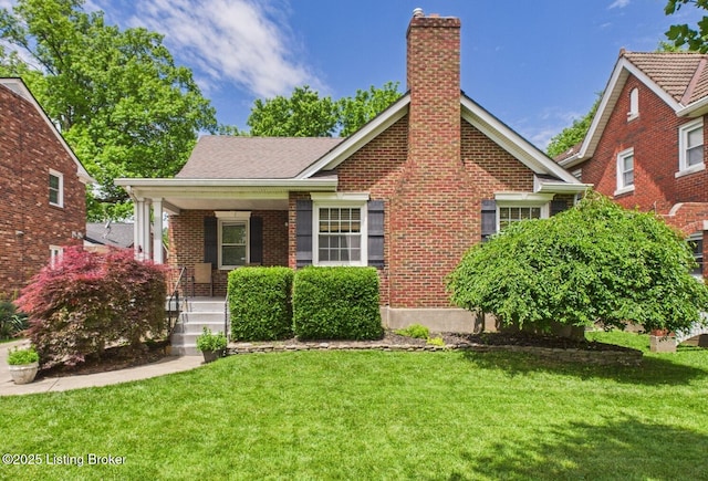4932 Southern Pkwy, Louisville, KY 40214 - view of front of house featuring covered porch, a front yard, brick siding, and a chimney