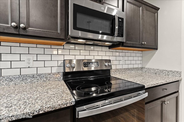 102 Limestone Ct, Shepherdsville, KY 40165 - kitchen featuring stainless steel appliances, backsplash, dark brown cabinets, and light stone countertops