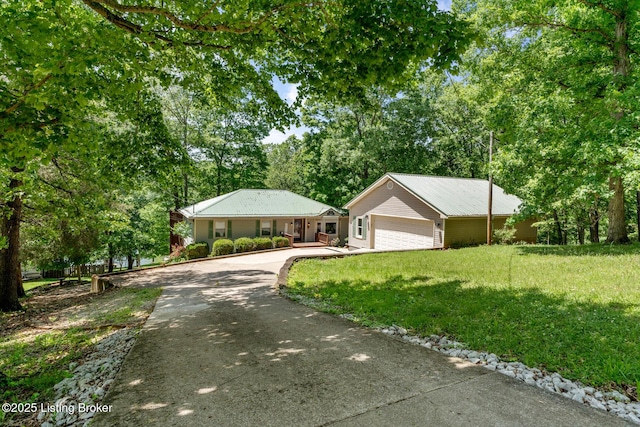 94 Tarnwood Dr, Brandenburg, KY 40108 - single story home with concrete driveway, a front lawn, view of wooded area, and a garage