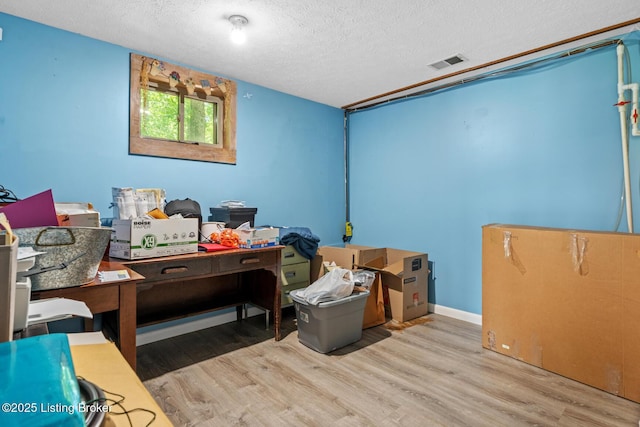 94 Tarnwood Dr, Brandenburg, KY 40108 - bedroom with a textured ceiling, wood finished floors, and a desk