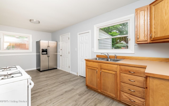 1057 Hillview Blvd, Shepherdsville, KY 40229 - kitchen with stainless steel fridge, a sink, light wood finished floors, light countertops, and white range with gas stovetop