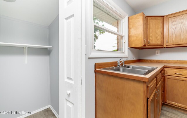 1057 Hillview Blvd, Shepherdsville, KY 40229 - kitchen with a sink, light wood-style flooring, light countertops, and baseboards