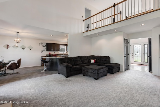 6820 Grandfield Rd, Louisville, KY 40258 - living room featuring a chandelier, baseboards, light carpet, recessed lighting, and a towering ceiling