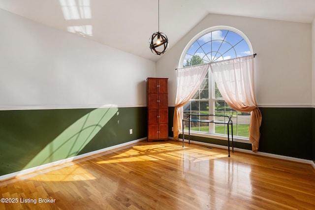 6820 Grandfield Rd, Louisville, KY 40258 - spare room featuring light wood-type flooring, vaulted ceiling, baseboards, and a chandelier