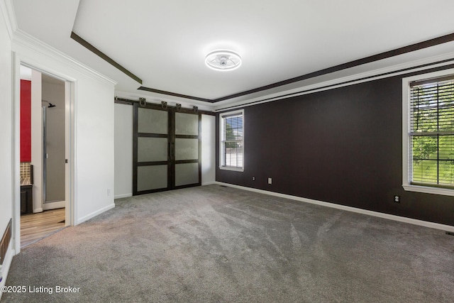 6820 Grandfield Rd, Louisville, KY 40258 - unfurnished bedroom with ornamental molding, carpet floors, baseboards, and a barn door