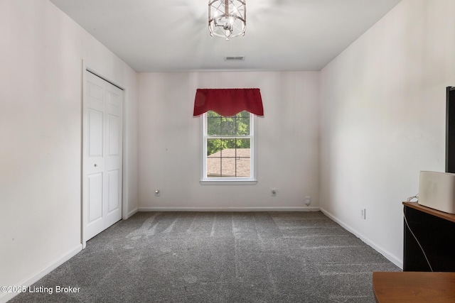 6820 Grandfield Rd, Louisville, KY 40258 - unfurnished bedroom with carpet, baseboards, a closet, and a chandelier