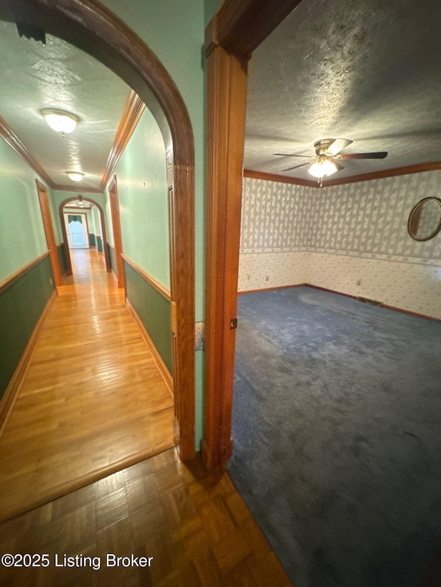 5309 Bardstown Rd, Springfield, KY 40069 - hallway featuring arched walkways, wallpapered walls, crown molding, and a textured ceiling