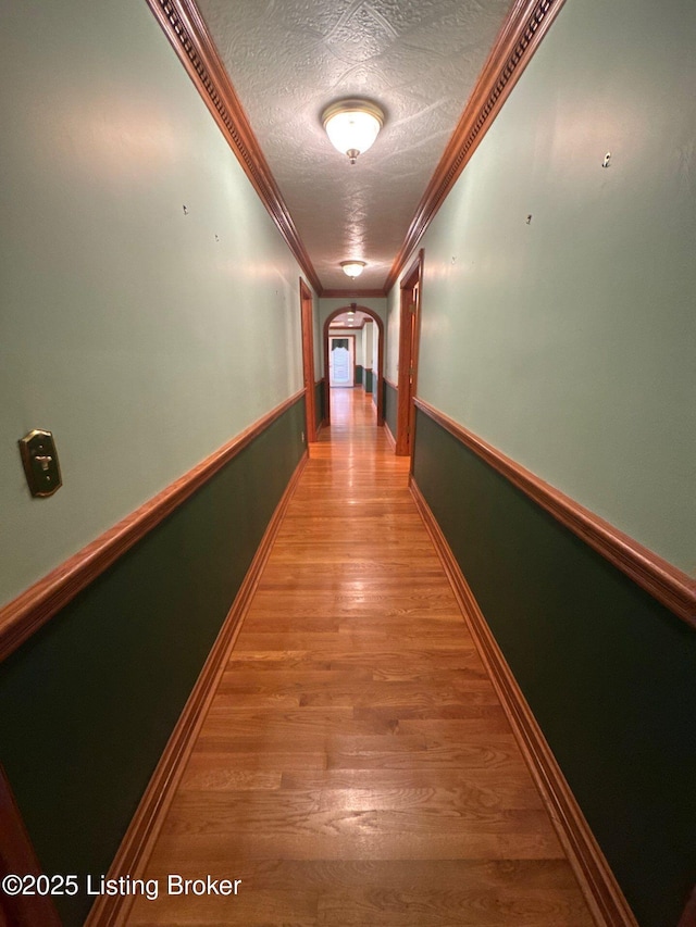 5309 Bardstown Rd, Springfield, KY 40069 - corridor with arched walkways, light wood-type flooring, a textured ceiling, and ornamental molding