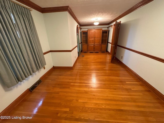 5309 Bardstown Rd, Springfield, KY 40069 - hallway featuring ornamental molding, light wood finished floors, and a textured ceiling