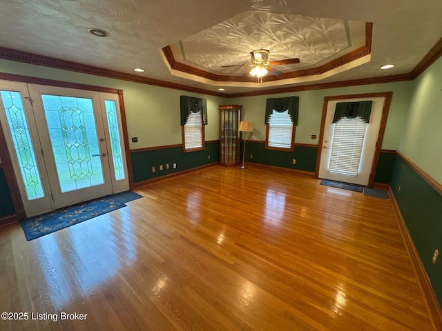 5309 Bardstown Rd, Springfield, KY 40069 - foyer with a tray ceiling, ornamental molding, wood finished floors, ceiling fan, and a wainscoted wall