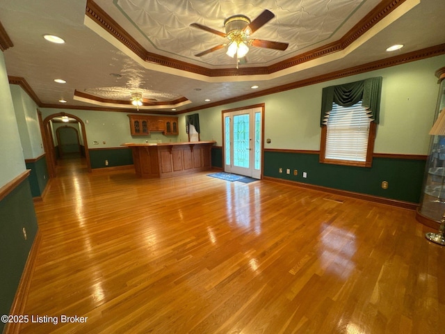5309 Bardstown Rd, Springfield, KY 40069 - unfurnished living room featuring a raised ceiling, crown molding, a ceiling fan, wood finished floors, and recessed lighting