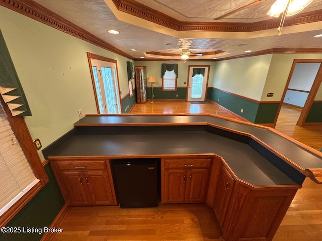 5309 Bardstown Rd, Springfield, KY 40069 - kitchen featuring a tray ceiling, dark countertops, crown molding, ceiling fan, and light wood finished floors