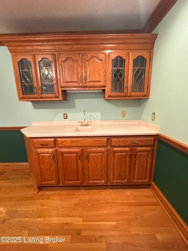 5309 Bardstown Rd, Springfield, KY 40069 - kitchen featuring glass insert cabinets, light countertops, and brown cabinetry