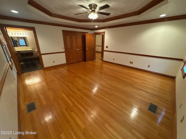 5309 Bardstown Rd, Springfield, KY 40069 - unfurnished living room with a tray ceiling, crown molding, a ceiling fan, light wood-style floors, and recessed lighting
